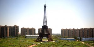 This picture taken on August 7, 2013 shows a replica of the Effel Tower in Tianducheng, a luxury real estate development located in Hangzhou, east China's Zhejiang province. China's ability to reproduce foreign products is best known for imitation luxury purses and copies of Hollywood films. But knockoffs have ranged from a three-dollar version of Kate Middleton's engagement ring to fake Apple stores and an entire Austrian village. CHINA OUT AFP PHOTO